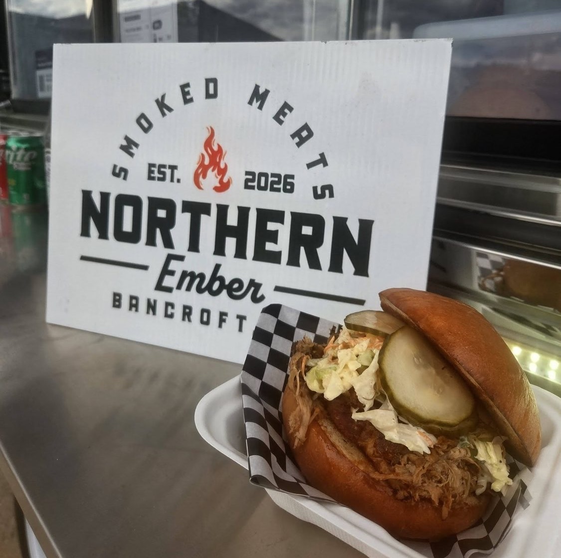 Pulled pork sandwich with creamy slaw and pickles, served fresh from the Northern Ember truck