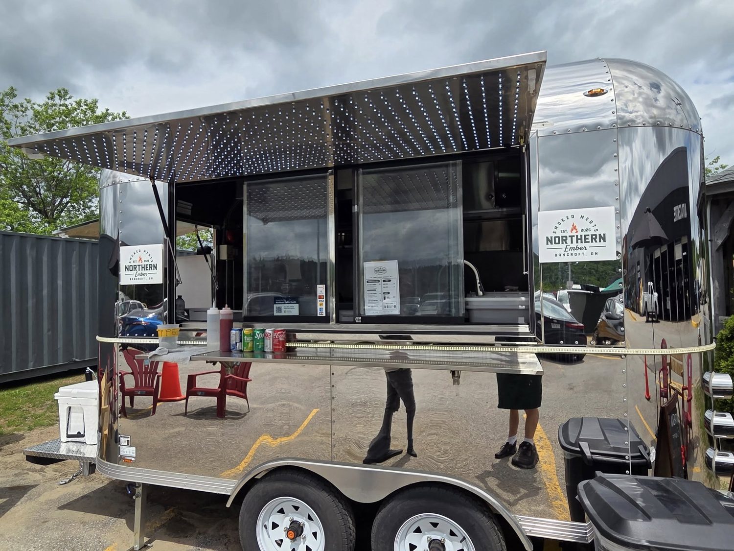 The Northern Ember Smoke BBQ food truck, an Airstream-style trailer with an open awning